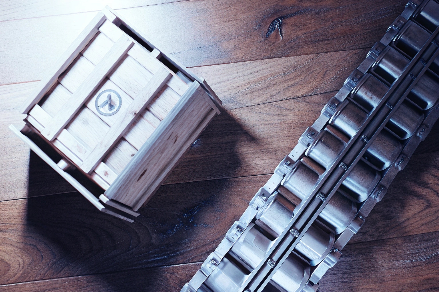 Small wooden crate next to a metal roller conveyor system on a wood floor.