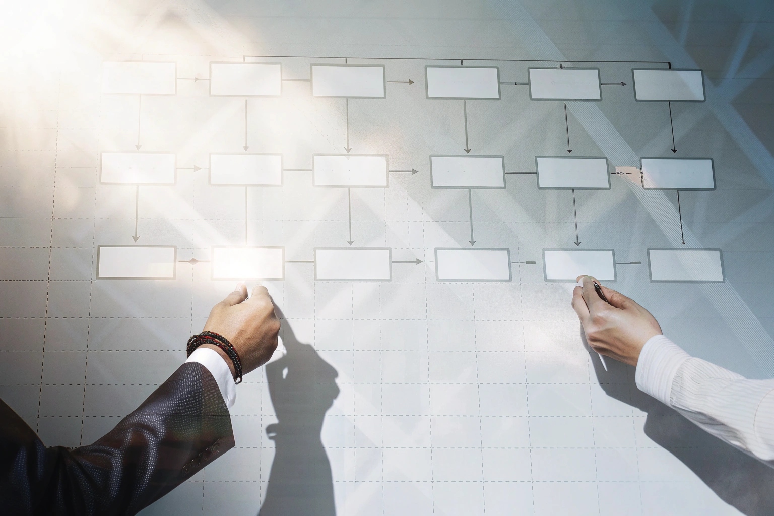 Business professionals collaborating on a digital flowchart for process optimization.